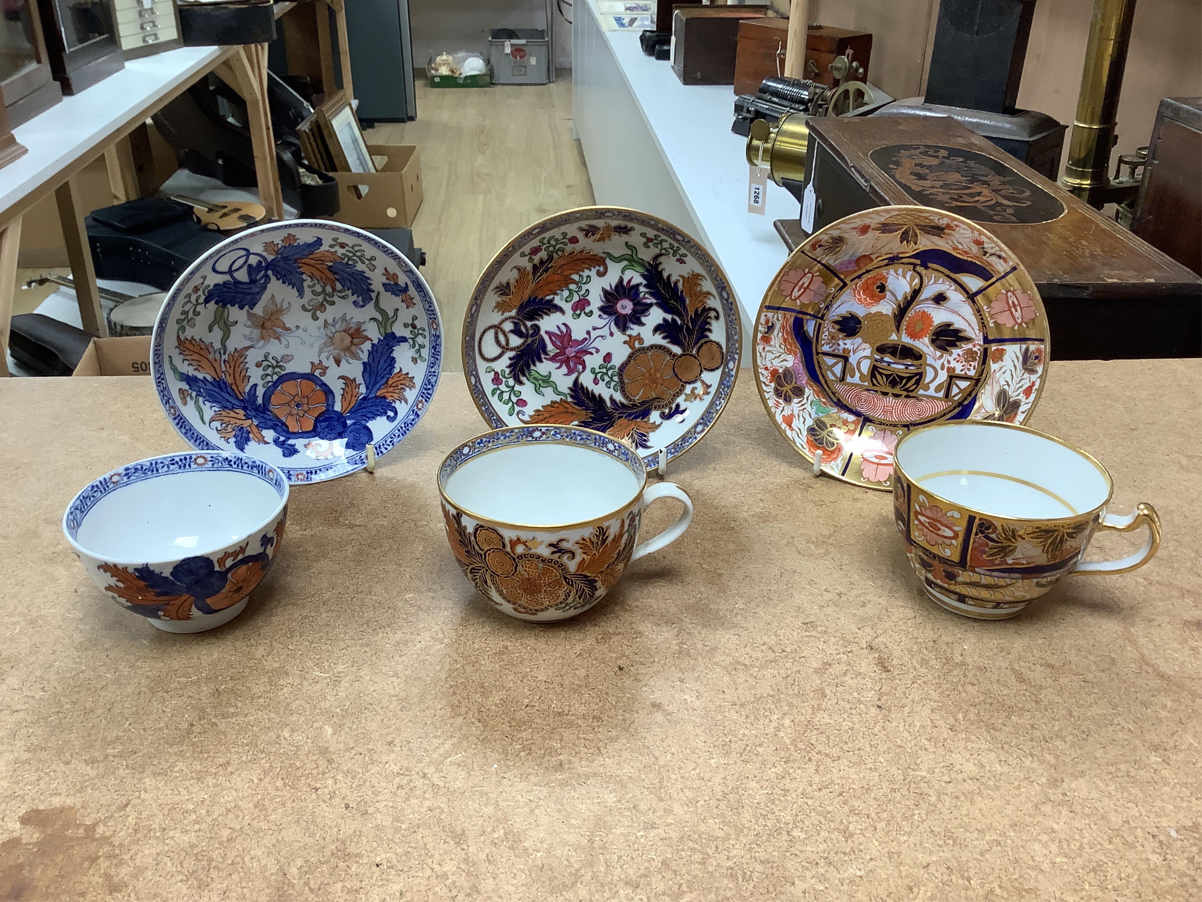 Six mixed English 1800-1820 porcelain cabinet cups and saucers, three similar coffee cans and saucers, a matching spoon stand and two coffee cans, a saucer dish, coffee can plus saucer and a tea bowl and matching saucer